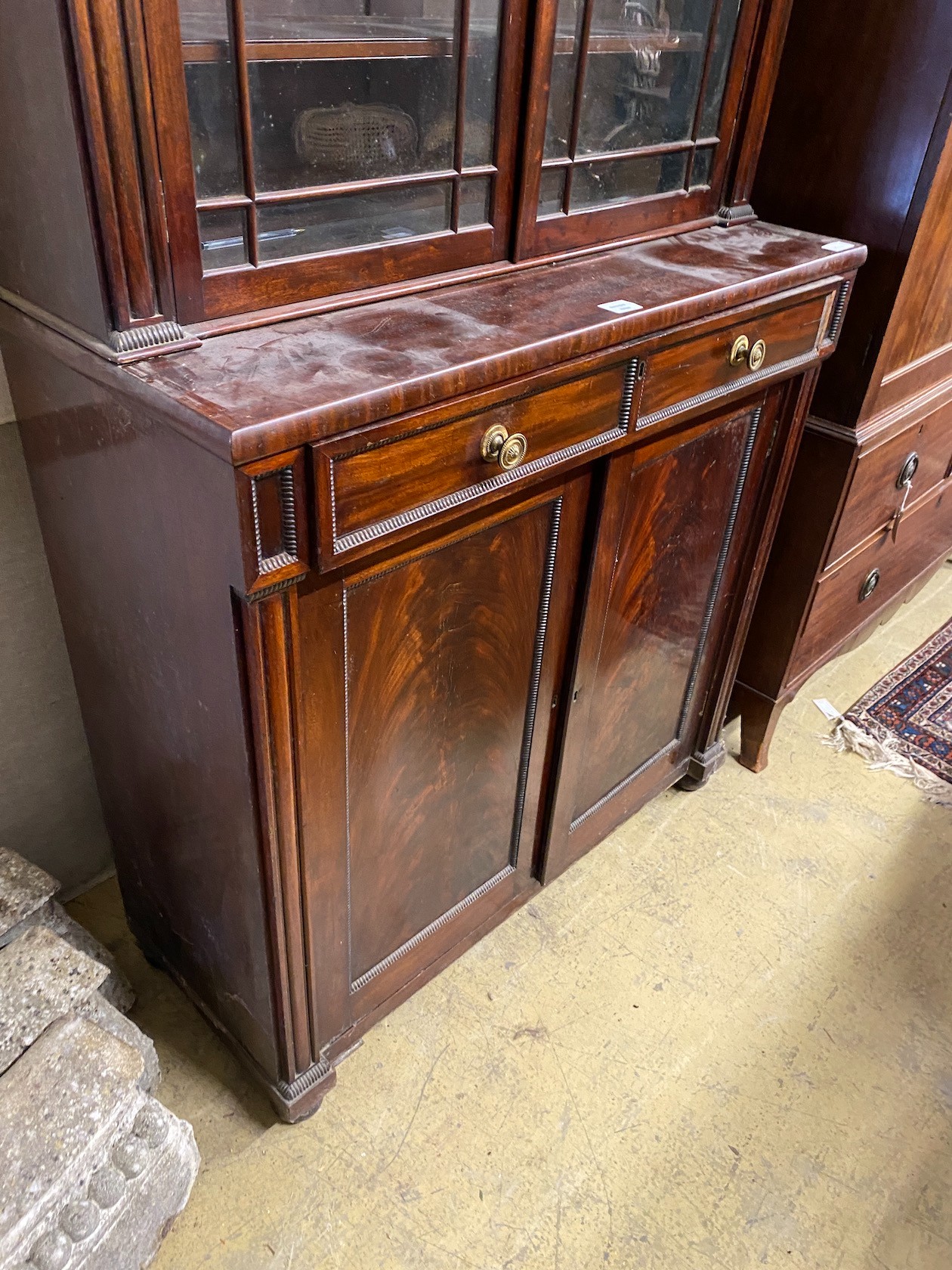 A Regency mahogany bookcase / cupboard, width 106cm, depth 44cm, height 226cm